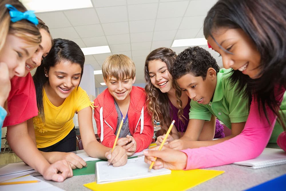 Students working together around a classroom table